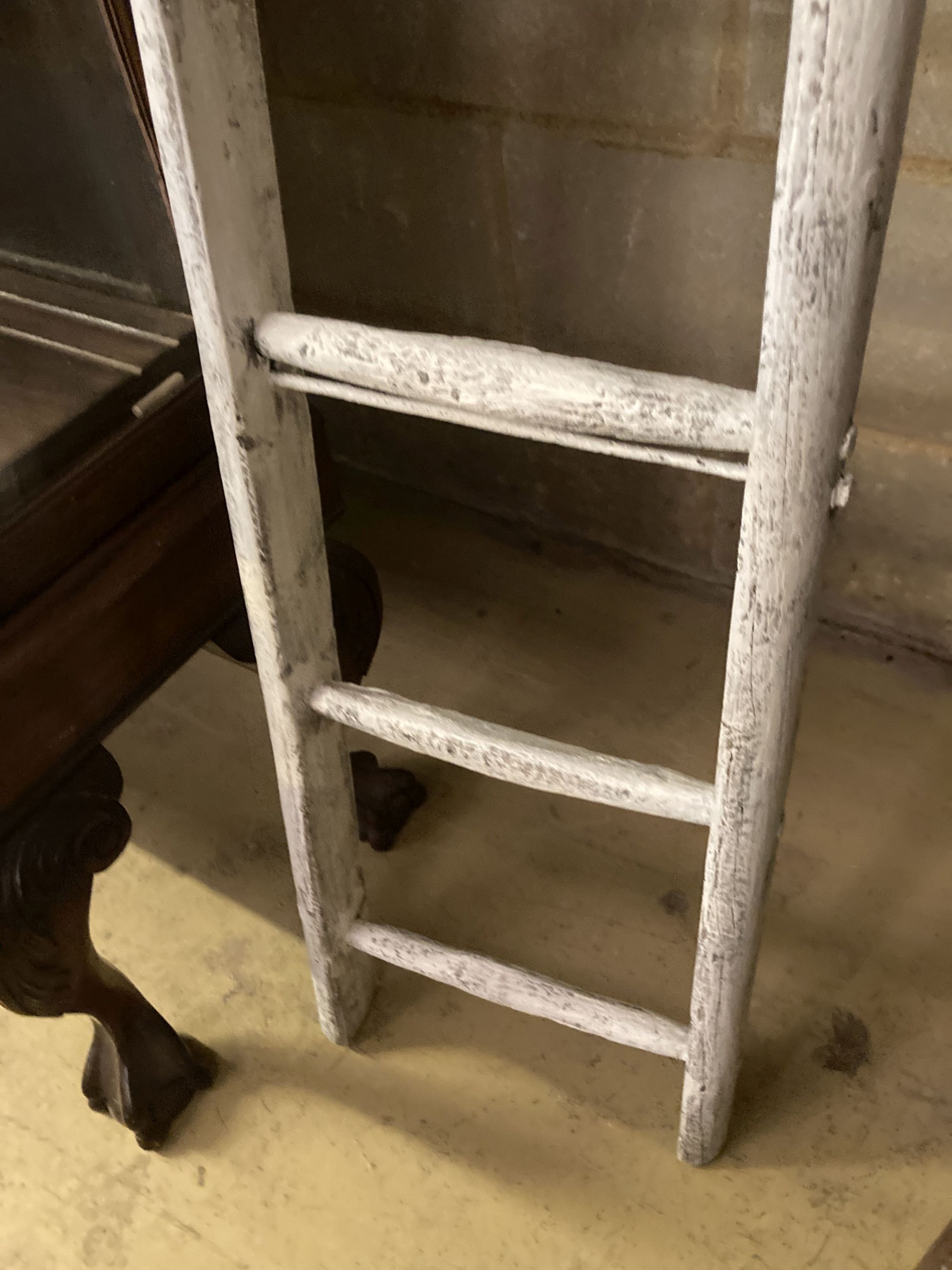 A vintage white painted wood seven tread ladder, width 30cm, height 170cm